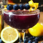 A refreshing Blueberry-Lemon Cocktail with garnished blueberries and lemon slices.