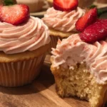 Strawberry cupcakes with creamy strawberry buttercream frosting on a pink plate