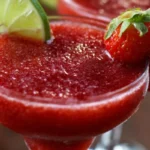 Strawberry Rum Cocktail garnished with fresh strawberries and mint leaves