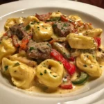 Savory cheesesteak tortellini in creamy provolone sauce